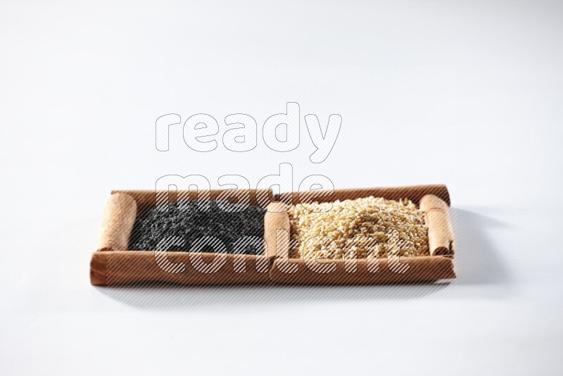 2 squares of cinnamon sticks full of sesame and black seeds on white flooring
