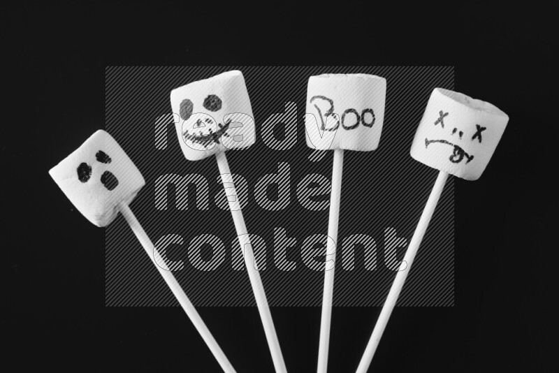 Halloween shapes on marshmallows on black background