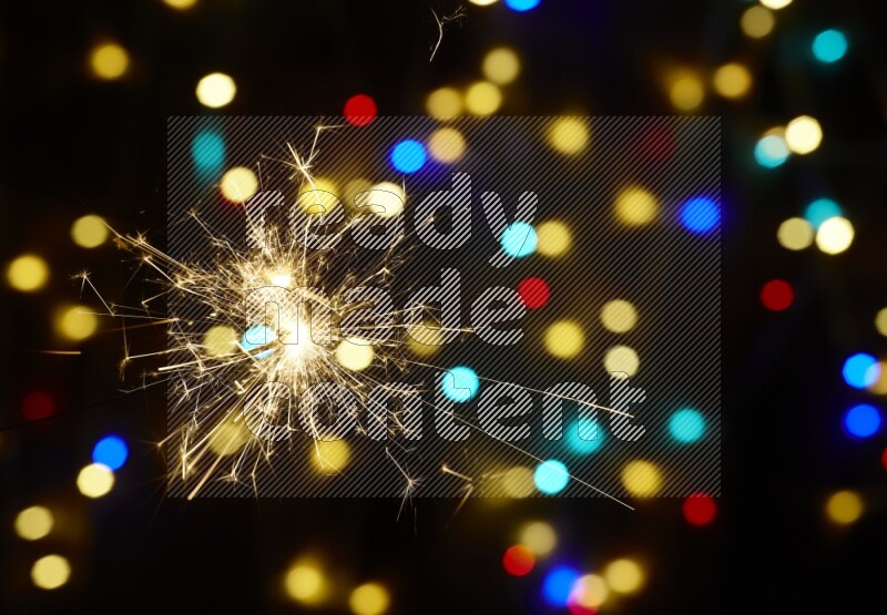 Sparkler candles with multicolored light bokeh background