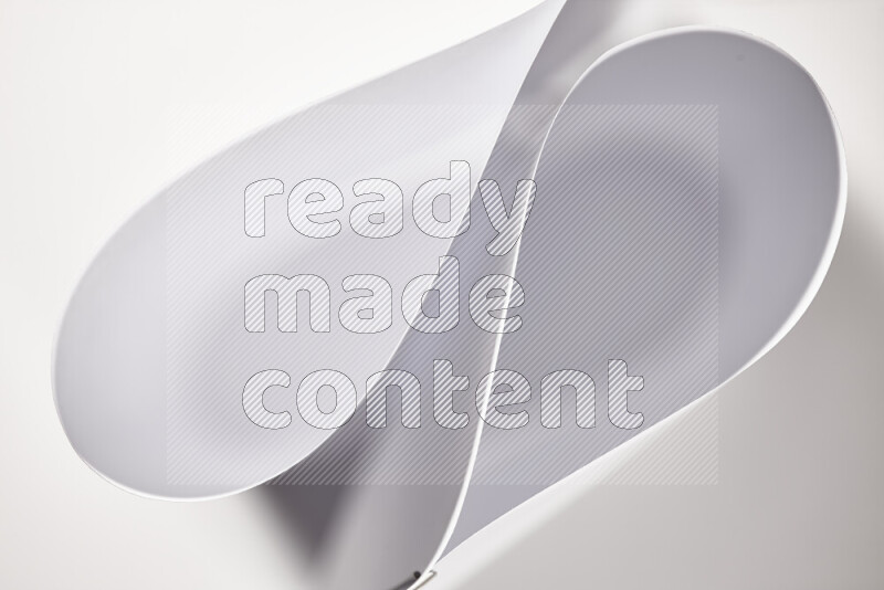 An abstract art of paper folded into smooth curves in grey gradients