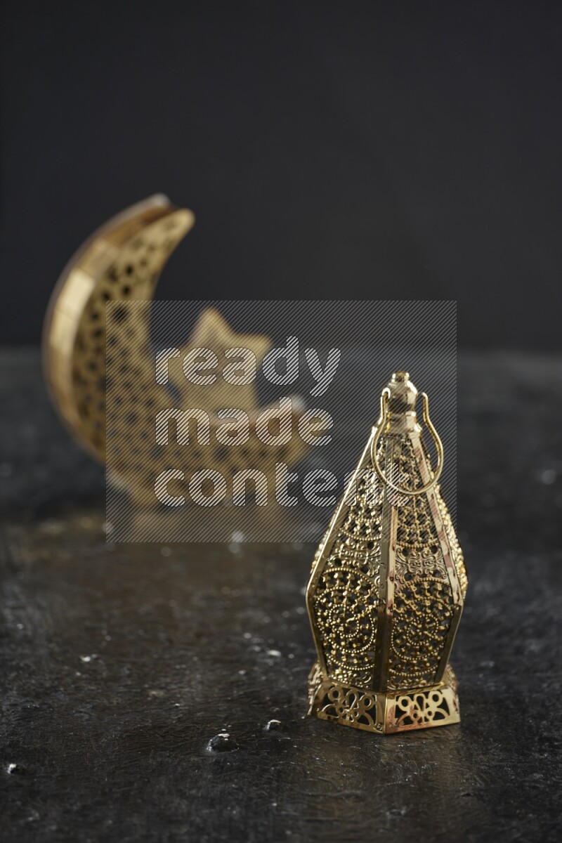 A crescent lantern with classic lantern on textured black background