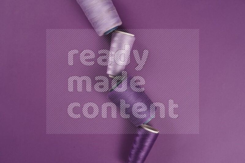 A purple collection of sewing and tailoring tools arranged on a purple background
