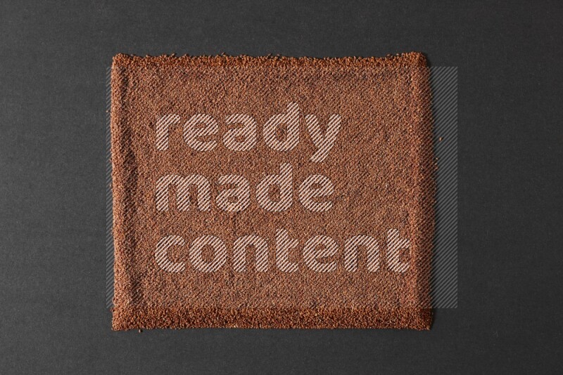 Garden cress seeds filling the frame on a black flooring