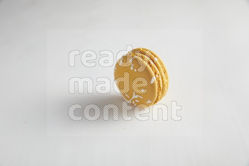 45º Shot of Yellow Piña Colada macaron on white background