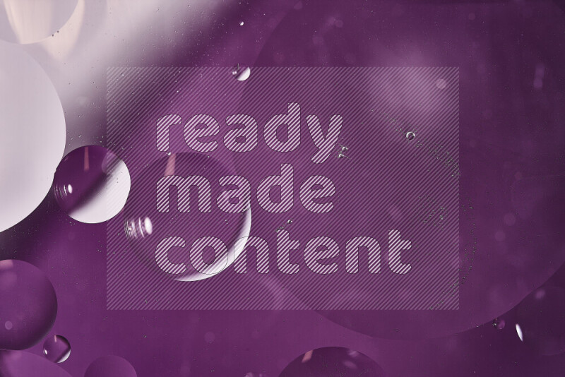 Close-ups of abstract oil bubbles on water surface in shades of white and purple