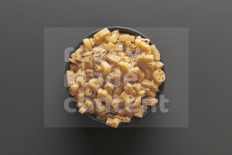 Shaped children pasta on grey background