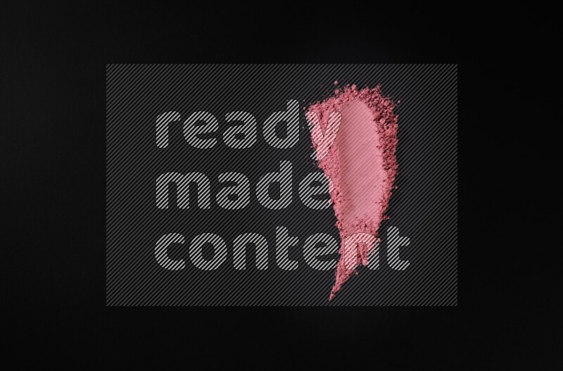 Red powder smears on black background