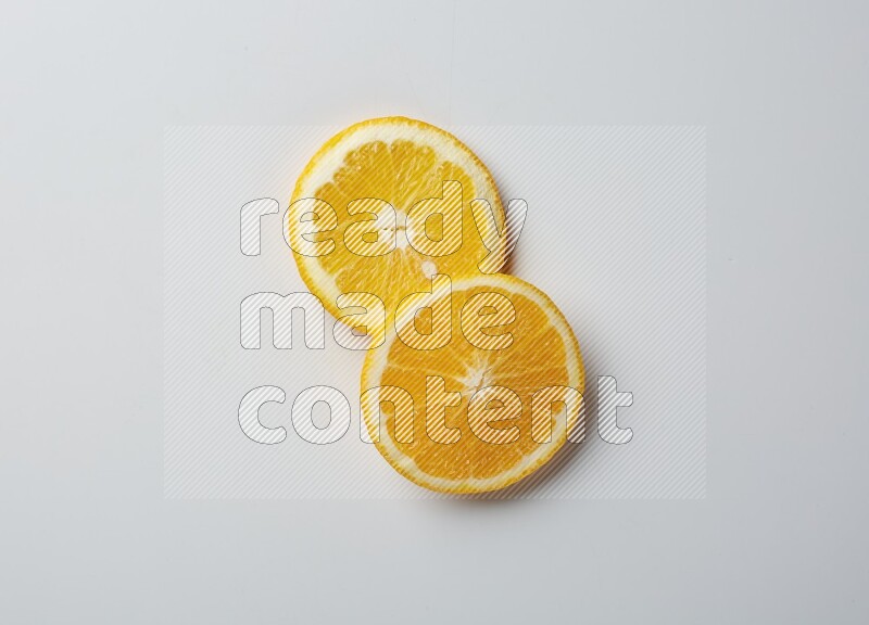 Two orange slices on white background