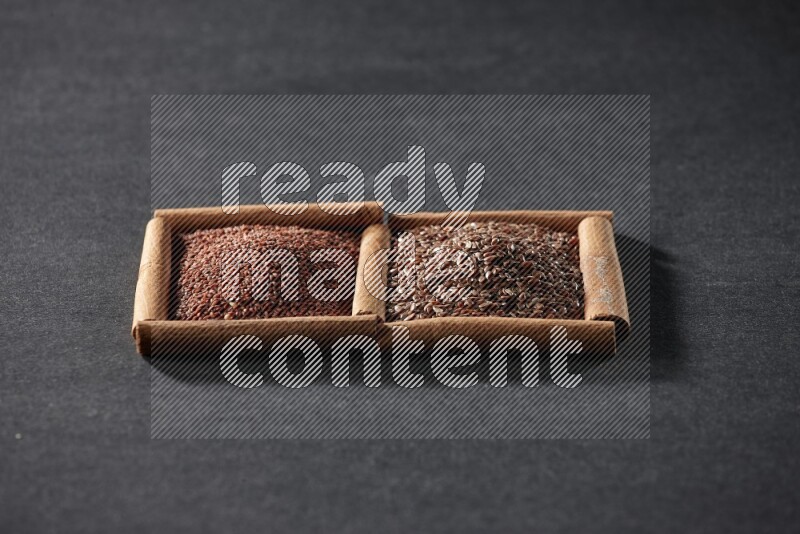 2 squares of cinnamon sticks full of garden cress and flaxseeds on black flooring