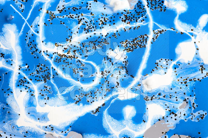 Abstract colorful background with mixed of blue and white paint colors with scattered gold glitter