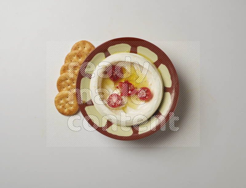 Lebnah garnished with Cherry tomato in a traditional plate on a white background