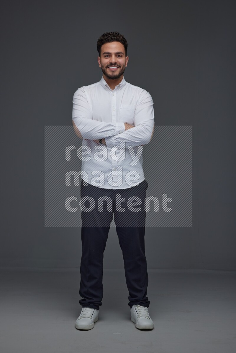A man wearing smart casual making multi stand poses  eye level on a gray background