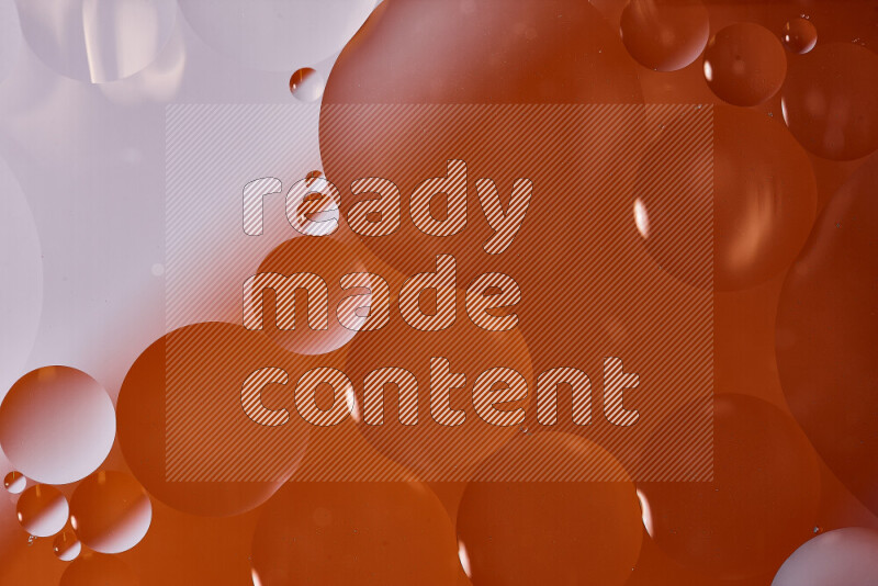 Close-ups of abstract oil bubbles on water surface in shades of white and orange