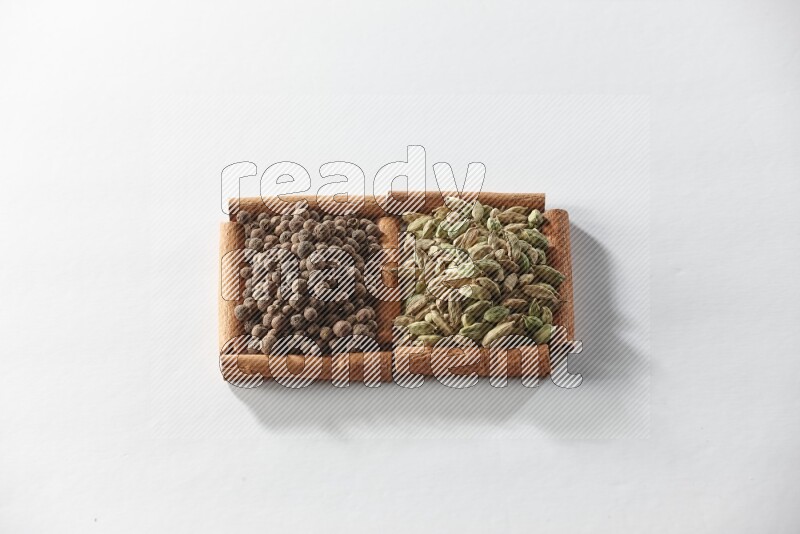 2 squares of cinnamon sticks full of cardamom and allspice on white flooring