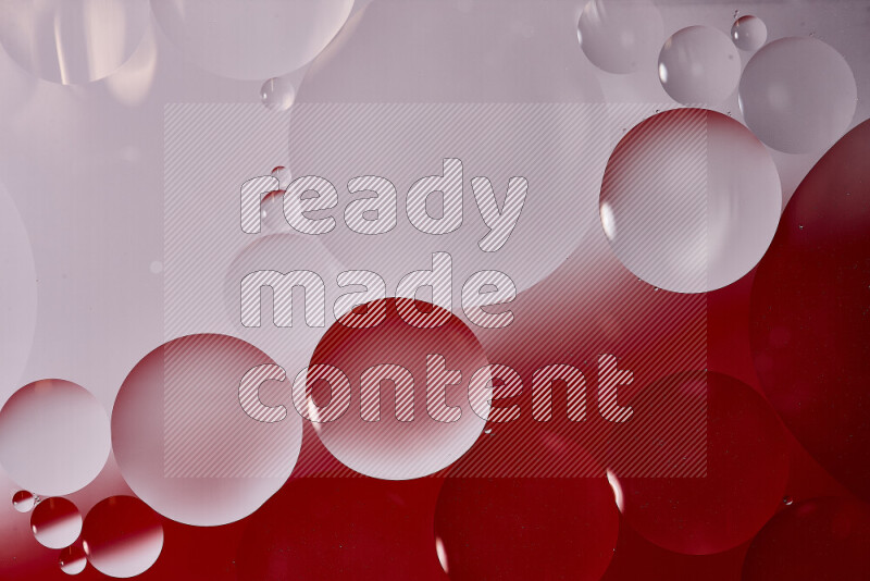 Close-ups of abstract oil bubbles on water surface in shades of white and red