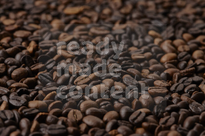 Roasted coffee beans on beige background