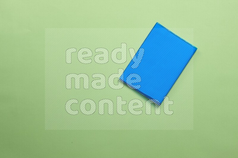 Multicolored notebooks on green background