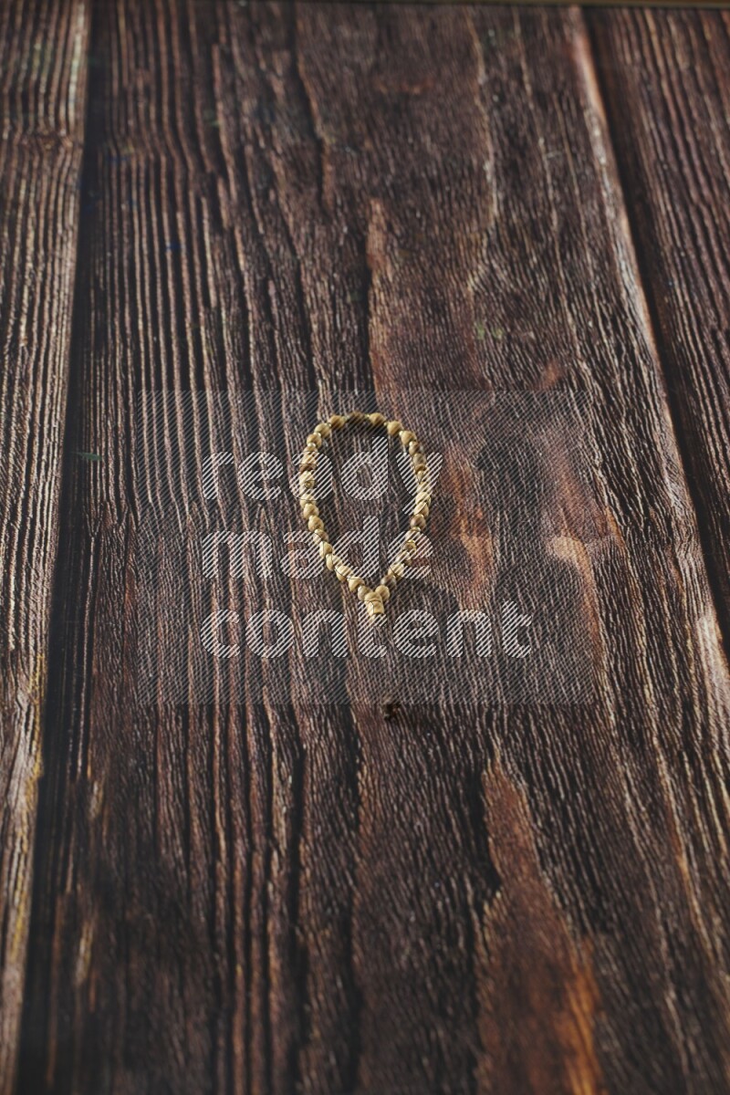 A prayer beads placed on wooden background