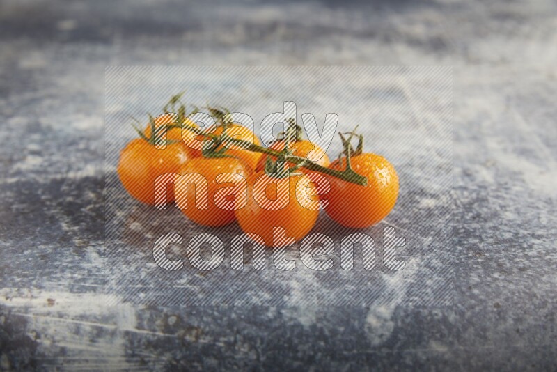 Orange cherry tomato vein on a textured rusty blue background 45 degree