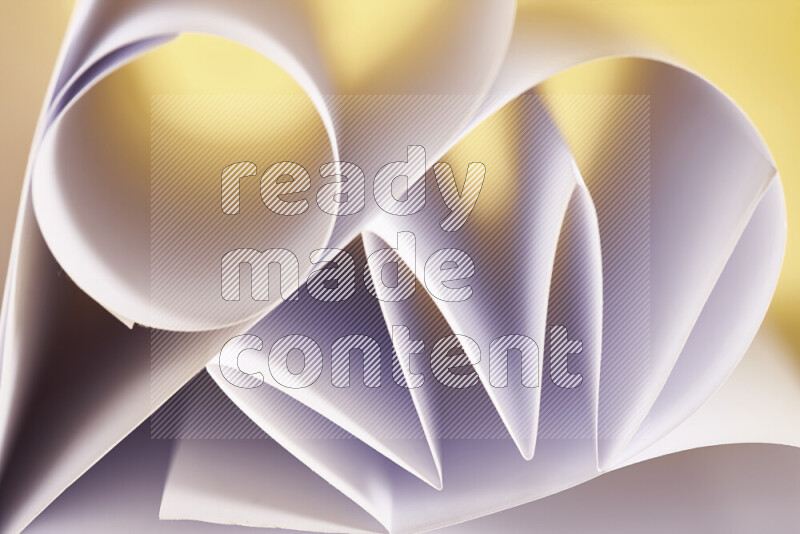 An artistic display of paper folds creating a harmonious blend of geometric shapes, highlighted by soft lighting in white and gold tones