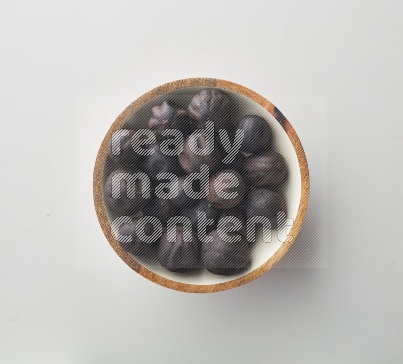 Top-view shot of dried lime (loomi) in a container on white background
