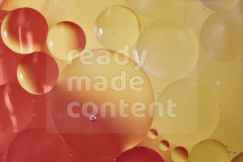 Close-ups of abstract oil bubbles on water surface in shades of red and yellow