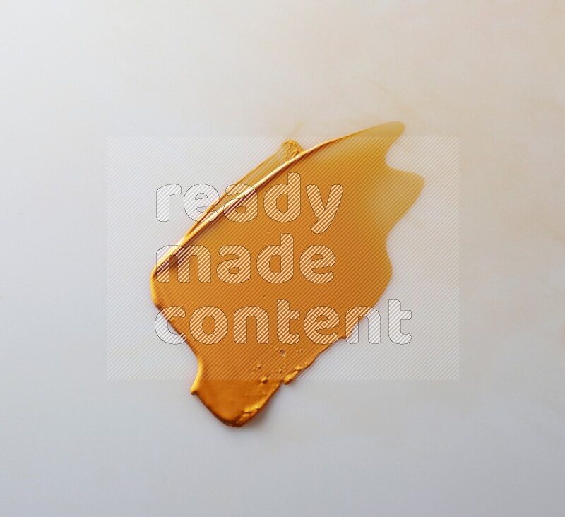 An orange single curved painting knife stroke on white background
