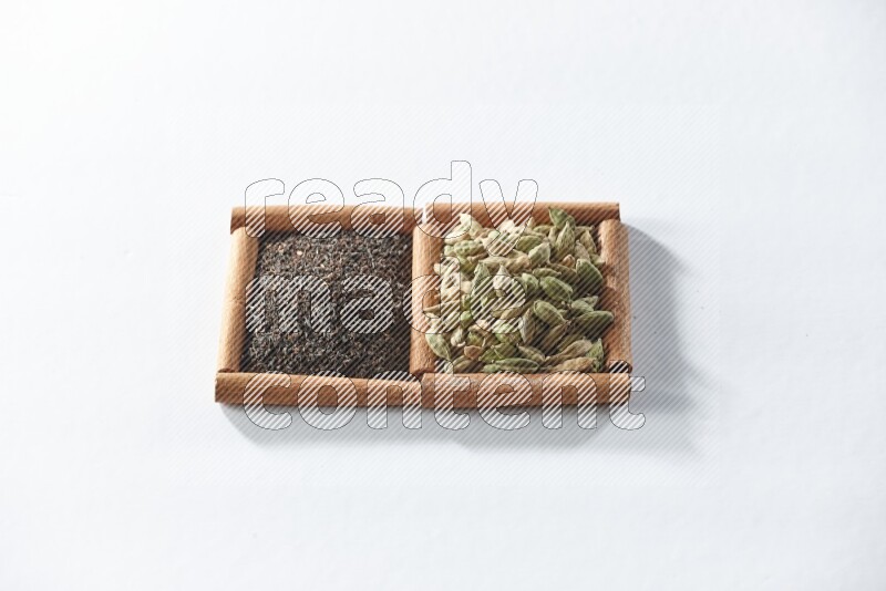 2 squares of cinnamon sticks full of black tea and cardamom on white flooring