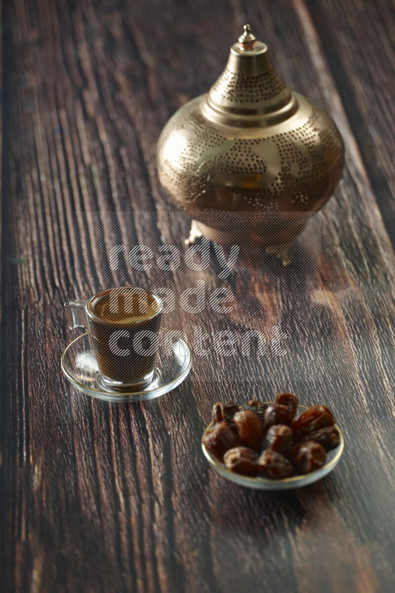 A golden lantern with different drinks, dates, nuts, prayer beads and quran on brown wooden background
