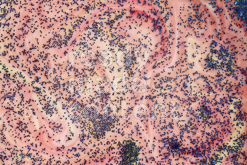 لقطة مقربة لبريق أزرق متلألئ منتشر على خلفية من اللون الأصفر والأحمر في حركات دائرية