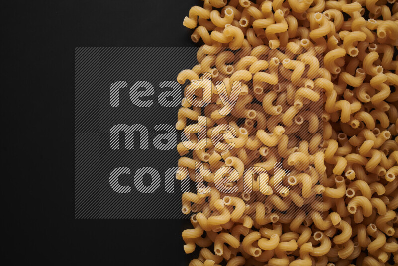 Different pasta types on black background
