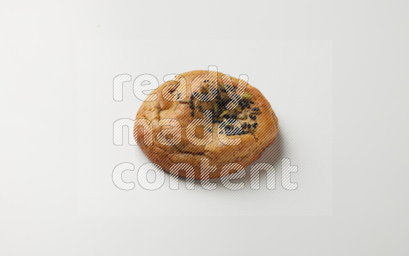 Hasawi cookie field with date and decorated by black seed and Anise grain on a white background
