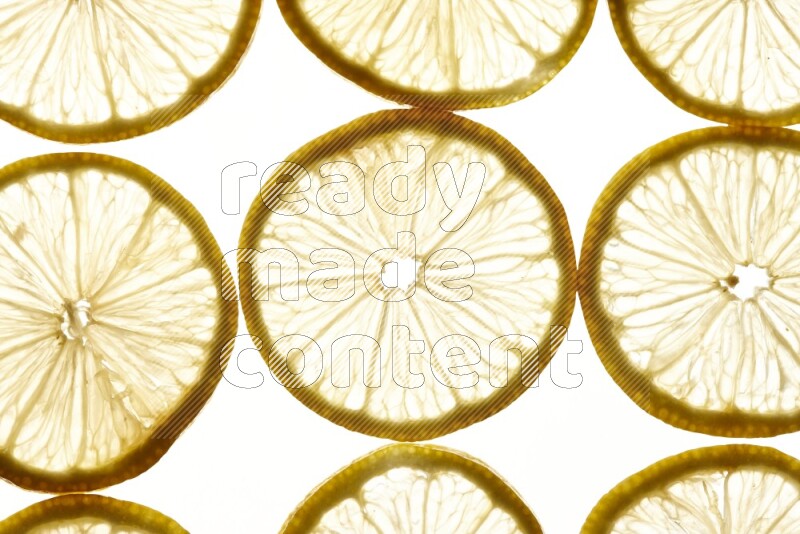 Lemon slices on illuminated white background