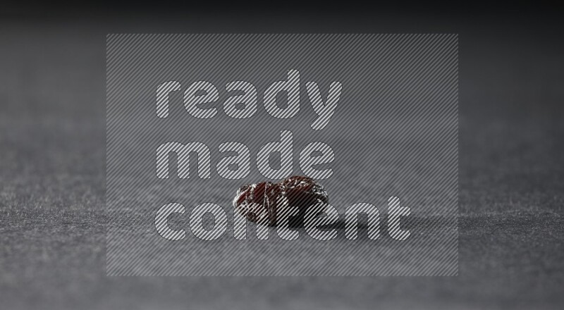 A dried plum on a black background in different angles