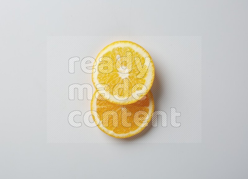Two orange slices on white background