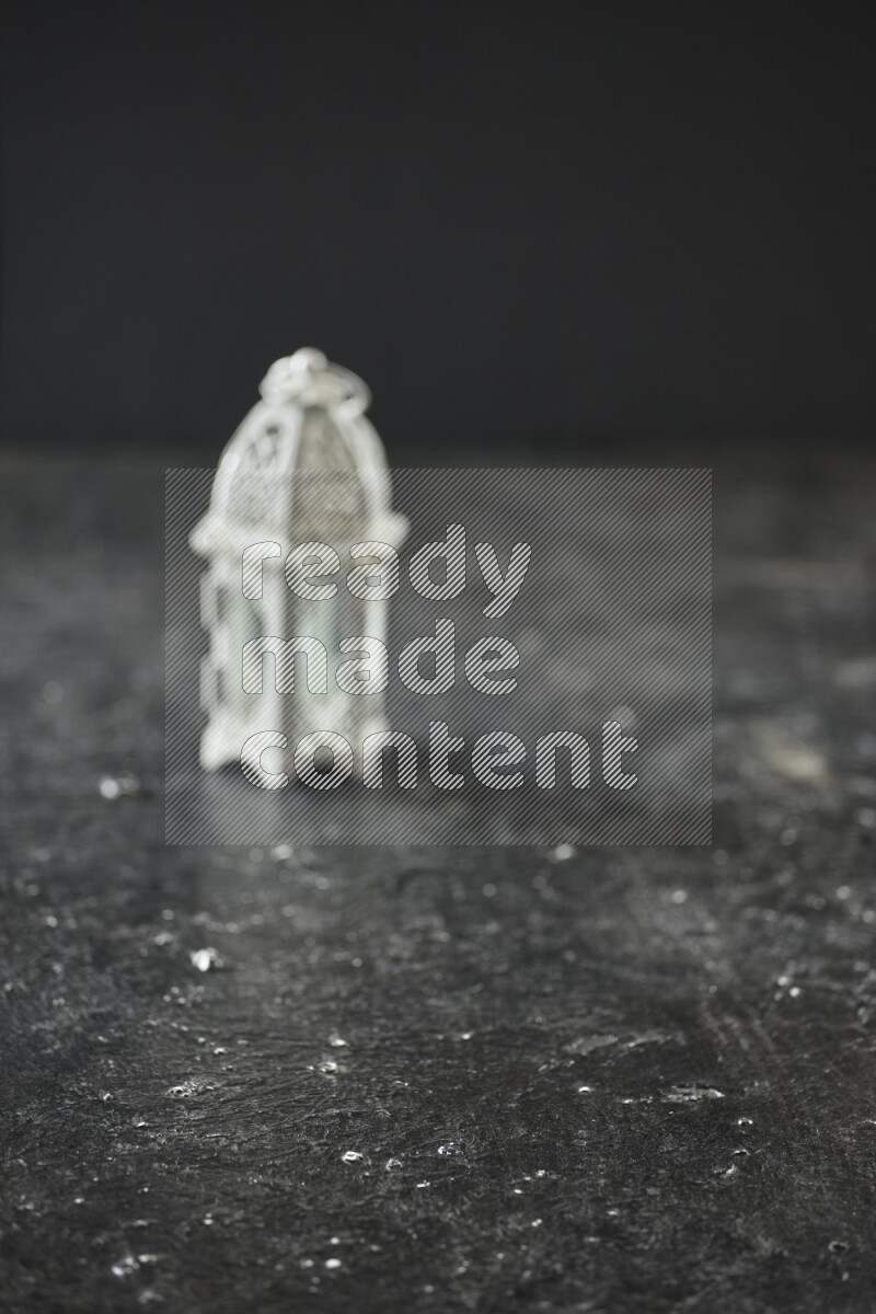 An out of focus lantern on textured black background