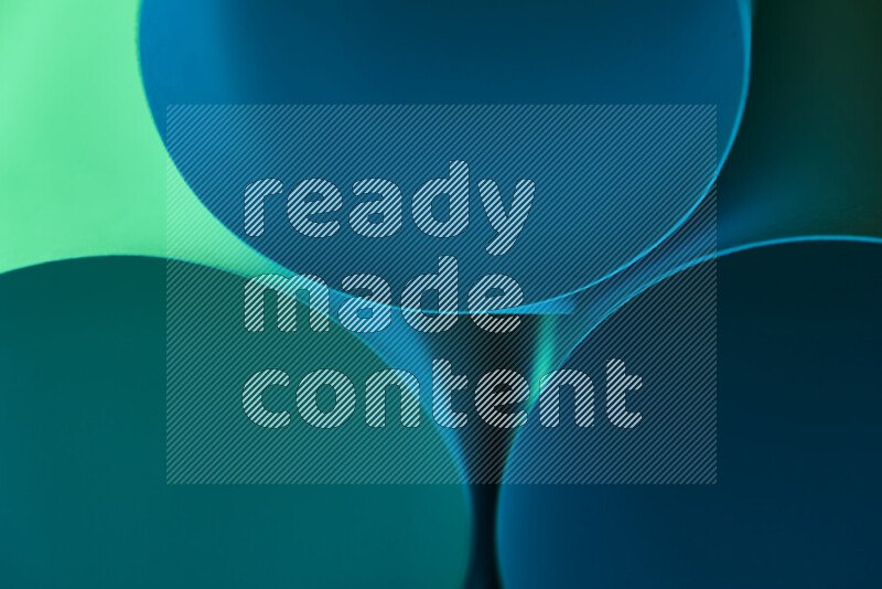 الصورة تعرض فن ورقي تجريدي بأشكال دائرية بدرجات متنوعة من اللون الأخضر والأزرق