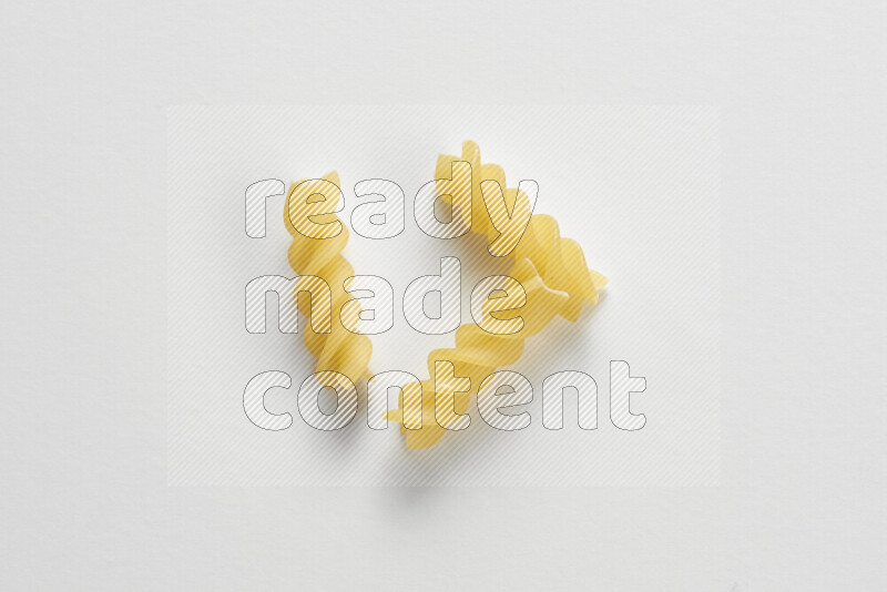 Fusilli pasta on white background