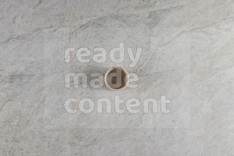 A multicolored pottery Cup on grey marble background