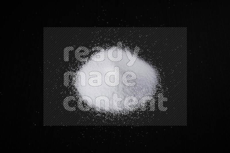 A bunch of fine table salt on black background