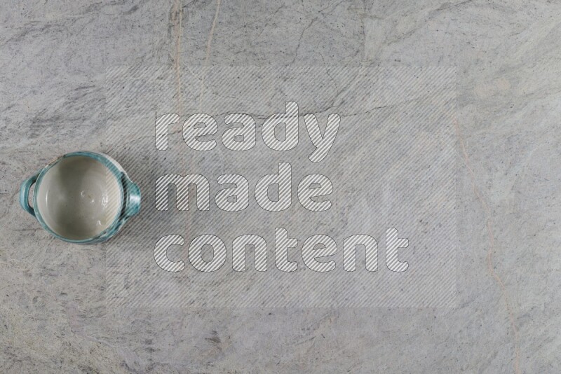 A multicolored pottery Bowl on grey marble background