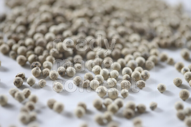 White pepper beads on white background