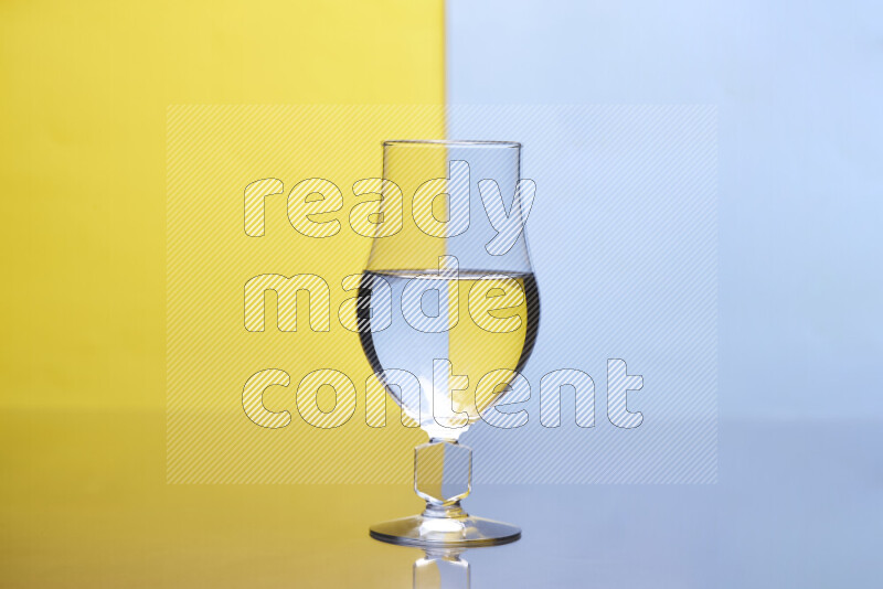 The image features a clear glassware filled with water, set against yellow and light blue background