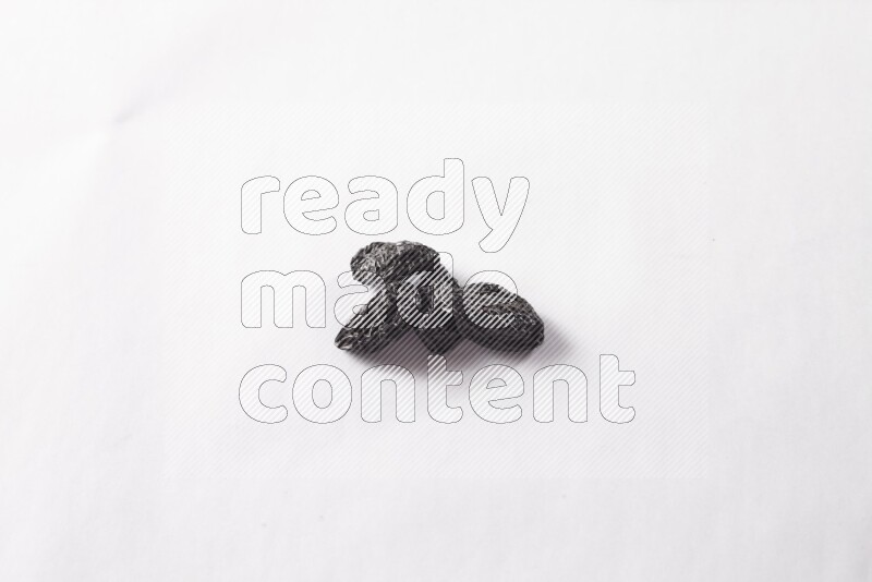 Dried plums on white background