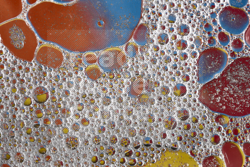 Close-ups of abstract soap bubbles and water droplets on multicolored background
