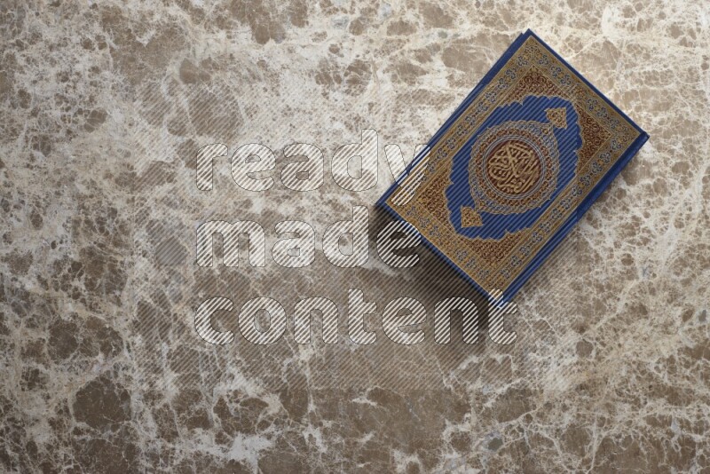 The holy Quran on beige marble background