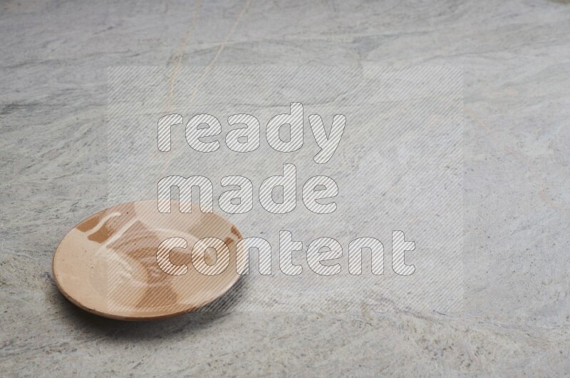 Multicolored Pottery Plate On Grey Marble Flooring