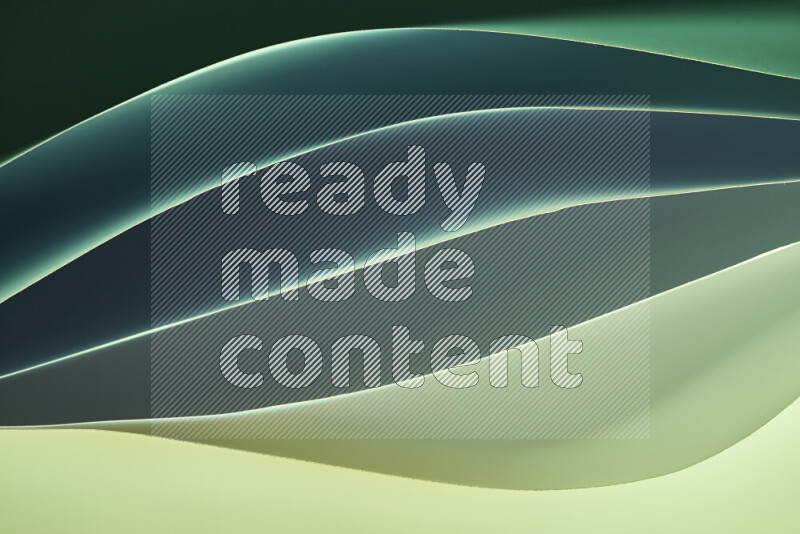 This image showcases an abstract paper art composition with paper curves in green gradients created by colored light