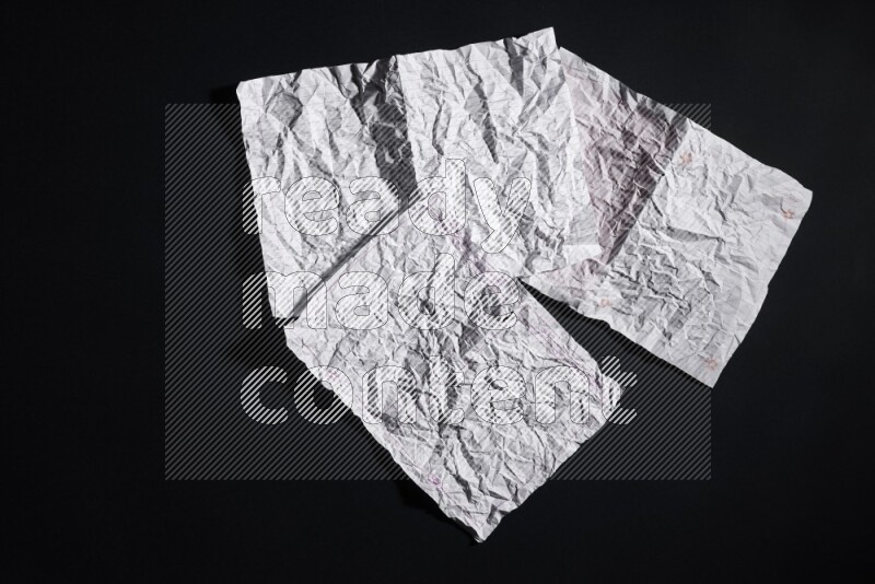 Crumpled notebook sheet on black background