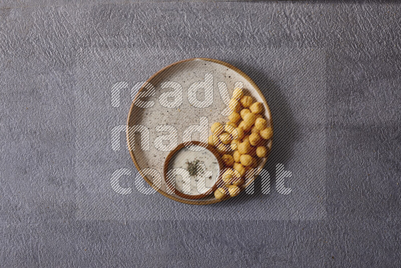Assorted snacks in pottery bowls on grey background